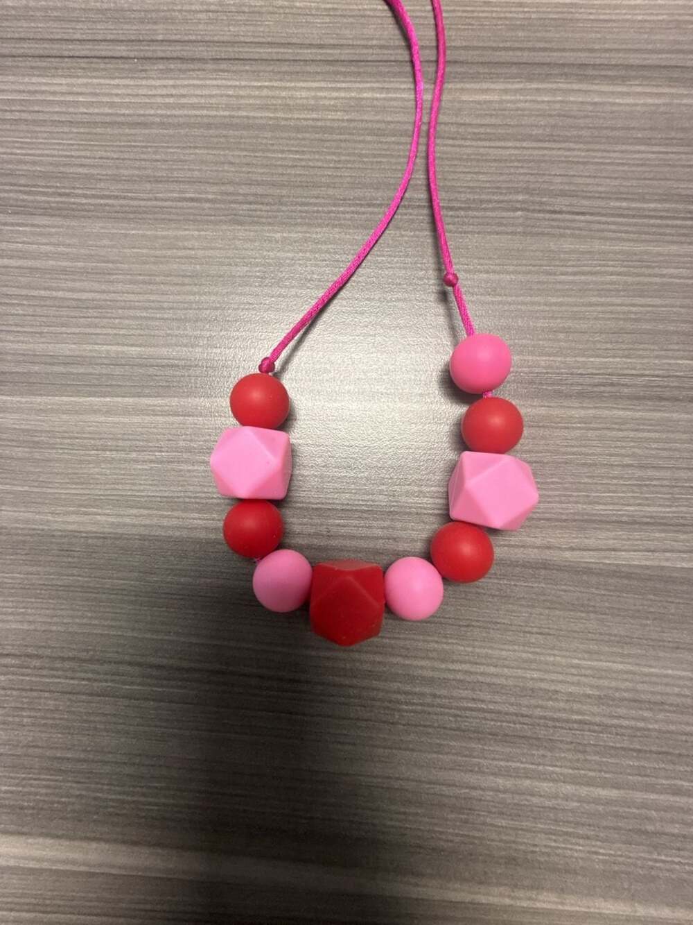 Silicone Teething Sensory Chew Necklace in Pink and Red - Picture 2 of 3